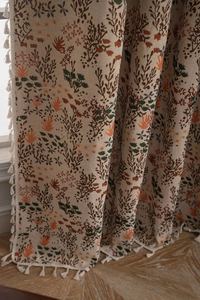 Detail view of Bohemian jacquard curtain fabric with colorful floral patterns and tassels