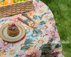 Detailed close-up of vintage floral jacquard tablecloth with rustic woven texture