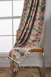 Close-up of colorful daisy floral woven tapestry with elegant white tassels on edges