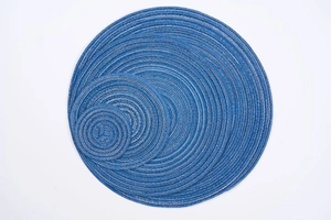 Detail of round woven placemats in blue and white cotton rope with spiral braided texture