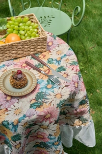 Close-up of vintage floral jacquard tablecloth with elegant white pleated lace border edge