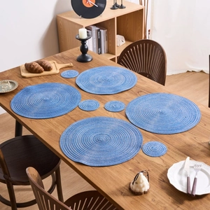 8-piece set of blue round woven cotton placemats and coasters with spiral texture design