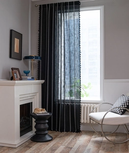 Detail of Nordic black line embroidery and tassels on semi-sheer bohemian curtains