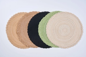 Macro detail of French pastoral round woven placemats with braided scalloped lace edges