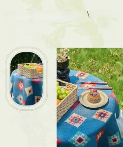 Detail of bohemian blue geometric jacquard tablecloth with elegant white lace edges