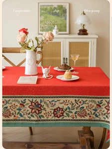 Close-up of red rectangular tablecloth with vintage floral jacquard lace and soft embroidery
