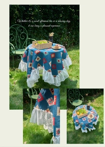 Close-up of bohemian blue geometric jacquard tablecloth with white lace trim detail