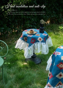 Detail of bohemian blue geometric jacquard tablecloth with white lace edges