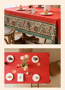 Detail of red jacquard tablecloth featuring intricate floral embroidery and woven lace borders