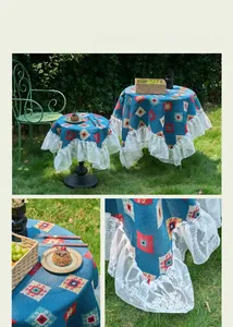 Detailed view of blue jacquard tablecloth with geometric patterns and white lace ruffles