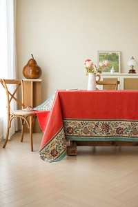 Detail of red wedding tablecloth featuring intricate floral jacquard lace and vintage patterns