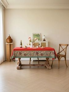 Detailed view of red rectangular tablecloth with vintage floral woven jacquard lace border