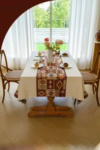 Close-up of bohemian red geometric jacquard tablecloth with textured cotton-linen fabric