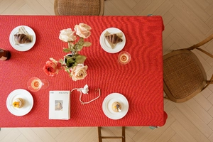Detail of red jacquard tablecloth with wave texture for festive wedding table settings