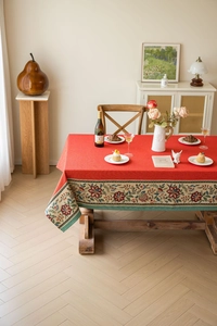 Detailed macro view of the festive red rectangular tablecloth with ethnic floral jacquard lace