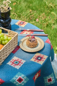 Detailed close-up of blue bohemian jacquard tablecloth with geometric patterns for outdoor picnic