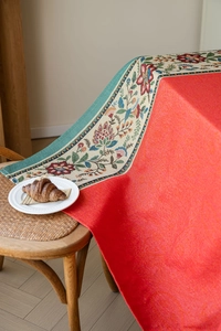 Detail of red jacquard tablecloth with bohemian floral woven lace borders for weddings
