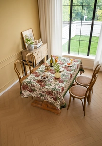 Close-up of vintage red rose jacquard floral tablecloth with elegant drape and hem