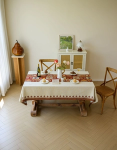 Close-up of bohemian red jacquard runner on beige tablecloth with geometric patterns