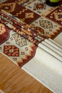Close-up of bohemian red jacquard tablecloth with intricate geometric patterns