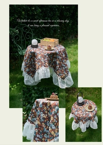 Detail of red floral tablecloth with white lace edges for outdoor garden tea party setting