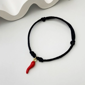 Adjustable black woven bracelet featuring a vibrant red chili cornetto charm