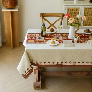 Bohemian table runner set with red geometric jacquard on a rustic wooden dining table