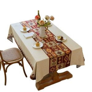 Bohemian red geometric jacquard tablecloth with tassel runner on a wooden dining table
