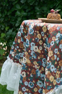 Detailed close-up of floral jacquard fabric with elegant white lace ruffled edges
