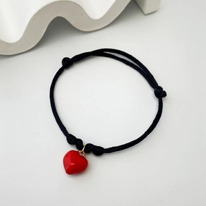 Minimalist black woven rope bracelet featuring a polished red heart pendant for women