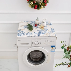 Blue and gold floral dust cover for washing machine on white marble countertop