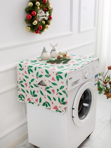 Close-up of Christmas cover with red berry prints, side storage pockets, and pompom tassels
