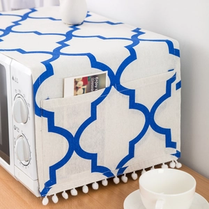 Blue and white geometric cotton linen microwave cover with side storage pocket and pompom trim