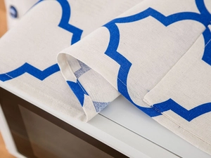 Close-up of durable cotton linen microwave cover featuring blue quatrefoil patterns