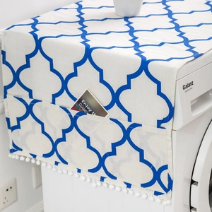 Blue geometric pattern dust cover with storage side pockets and white pompom tassels