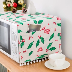 Christmas microwave dust cover in linen with holly patterns and white pompoms