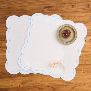 Set of two white cotton linen placemats with light blue embroidered scalloped edges