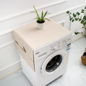 Detail of floral refrigerator dust cover with side storage pockets and white pom pom tassels