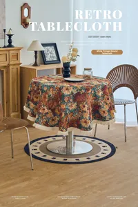 Detail of American retro round tablecloth with paisley floral pattern and white tassel trim