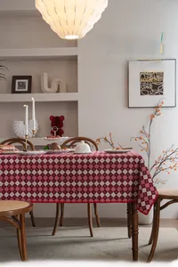 Detail of red and white checkered tablecloth with festive red scalloped wavy edge design