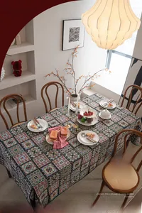 Detailed view of the thick jacquard texture and vintage geometric patchwork on the tablecloth