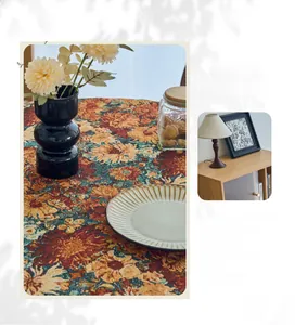 Detail of vintage jacquard tablecloth featuring floral patterns and thick woven texture