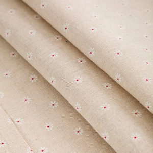 Close-up of linen fabric with daisy print showing texture and thickness of fridge cover