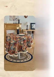 Detailed view of vintage paisley jacquard tablecloth featuring white fringe and retro floral patterns