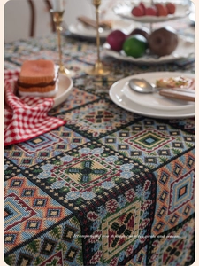 Close-up of vintage jacquard tablecloth featuring colorful geometric rhombus patterns