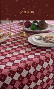Close-up of red and white checkered jacquard tablecloth with festive holiday dinner decor