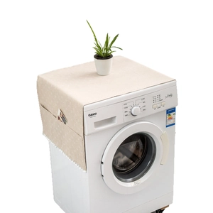 Daisy print dust cover for washing machines with side storage pockets and pom-pom trim