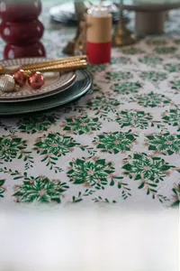 Festive Christmas tablecloth with green and gold floral prints for holiday dining setup