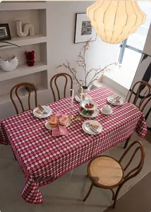 Detail of red and white checkered tablecloth with delicate scalloped wave edge embroidery