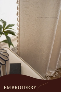Detailed view of cream jacquard embroidery curtain with elegant fringe tassels